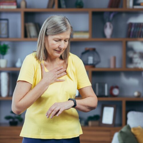 Older woman at home doing fitness has severe shortness of breath and chest pain, compares bullets on